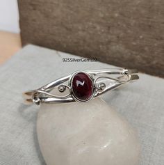 Welcome to our shop 925SilverGems22 Description:-  Style:- Bangle Advantages of Garnet Bangle:- It protects the wearer from negativity and evil thoughts. It induces passion, fire, energy, and stability, and is believed to bring good luck in love and relationships. Garnet is a stone meant to bring success in life and helps to achieve the goals set in life by its possessor. Occasion:- Anniversary Gift, Birthday Gift, Wedding Gift, Gift Bangle, Valentine's Gift, Engagement Gift, New Year Gift, Chri Sterling Silver Round Bracelet With Birthstone For Anniversary, Sterling Silver Oval Gemstone Cuff Bracelet, Oval Sterling Silver Gemstone Cuff Bracelet, Sterling Silver 925 Stamped Bracelets For Anniversary, Sterling Silver Spiritual Bracelet For Anniversary, Spiritual Sterling Silver Bangle With Gemstone, Spiritual Sterling Silver Gemstone Bangle, Silver Spiritual Birthstone Bracelets, Oval Gemstone Bangle As A Gift