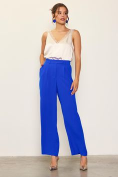 Wide-leg trousers are a staple in any season, but the pop color makes this pair especially fun. These tailored pants sit high on the waist, designed with an extended waist tab, a pleated front, and streamlined pockets. An elasticized back waistband makes for an extra-comfortable fit. •Long Pants •Elasticized waist •Double-tiered pleat •Laser-cut hems Item Number: 74266 Bright Blue Trousers Outfit, Cobalt Blue Pants Outfit, Blue Trousers Outfit, Cobalt Blue Pants, Blue Pants Outfit, Oc Things, Lace Trim Cami Top, Trouser Outfit, Pop Color