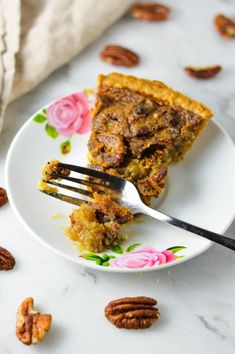 a piece of pecan pie on a plate with a fork