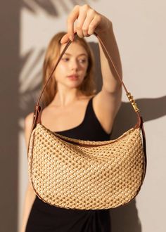 Indulge in luxury with our Woven Raffia Saddle Bag, expertly crafted with a blend of raffia and leather. Its adjustable shoulder strap ensures a perfect fit for women of all sizes. Elevate your style with this exclusive and elegant addition to your wardrobe. Size info 10 5/8" (27cm) width 6 3/4"(17cm) height 3"(8cm) depth Details Raffia and genuine cowhide leather Polyester lining Adjustable shoulder strap Interior wall pocket and zipper pocket Top zip closure Item #462501 Women's saddle shoulde Summer Woven Leather Bag With Round Handle, Vacation Shoulder Bag With Woven Leather And Round Handle, Chic Woven Leather Straw Bag With Top Handle, Luxury Straw Tote Shoulder Bag, Elegant Brown Crochet Bag With Woven Leather, Elegant Woven Leather Summer Bag, Elegant Woven Leather Shoulder Bag For Vacation, Luxury Leather Straw Bag With Adjustable Strap, Chic Natural Shoulder Bag With Round Handle