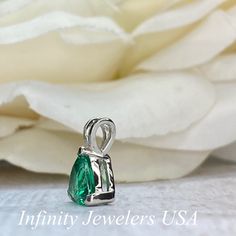 "The pendant pictured is a lab created emerald #6074 -Approximate total carat weight: approx. 1.80ctw diamond equivalent -Center Stone Size: 7x7mm - approx. 1.80ct diamond equivalent -Center Stone Shape: trillion -Gem Type: lab created emerald -Stone Clarity: VS2 -Stone Color: green -Moh's Scale: 8.5 hardness -Metal Type and Purity: 14k white gold -Setting: 3 prong basket head open back design -Chain: delicate 14k gold chain / heavier option with lobster claw available (use dropdown to select) - Teardrop Emerald Jewelry With Brilliant Cut, Fine Jewelry Emerald Teardrop Necklace For Anniversary, Fine Jewelry Teardrop Emerald Necklace For Anniversary, Pear-shaped Emerald Necklace In White Gold, Pear-shaped Emerald Necklace For Anniversary, Formal Emerald Teardrop Pendant Necklace, Green Teardrop Brilliant Cut Jewelry, Pear-shaped Emerald Gemstone Necklace, Green Teardrop Jewelry With Brilliant Cut