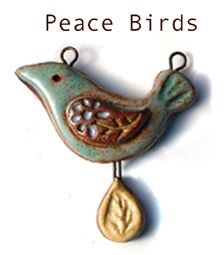 a small bird hanging from the side of a hook with words peace birds on it