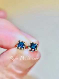 Princess cut blue sapphire bezel set stud 14k white earrings. Minimalist design earrings with deep rich blue tones. Sapphire is birthstone to September and holds great jewelry history. Each is bezel set in solid 14k white with 0.38 carat, 3.00mm square shape step cut sapphire. Center post allows these to be worn square or rotate in a diamond shape. Ready to ship. Blue Bezel Set Earrings For Formal Occasions, Blue Bezel Set Earrings For Gift, Minimalist Bezel Set Earrings For Formal Occasions, Minimalist Formal Earrings With Bezel Setting, Sapphire Hypoallergenic Jewelry For Anniversary, Hypoallergenic Sapphire Jewelry For Anniversary, Classic Sapphire Jewelry With Bezel Setting, Fine Jewelry Earrings With Tension Setting For Gift, Blue 14k Gold Jewelry With Tension Setting