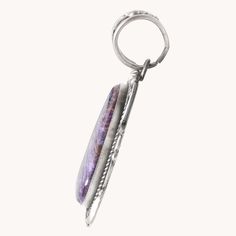 This Charoite Statement Pendant features a one-of-a-kind purple charoite stone, carefully handcrafted with unique silverwork. Made with stunning sterling silver, this pendant is the perfect addition to any jewelry collection. The elegant design adds a touch of sophistication to any outfit, making it a must-have for any fashion-forward individual. Sterling Silver Pendant Charoite Stone 3 1/4" Length (including bail), 1 1/2" Width Artist: R. Tom (hallmarked) Outfit Making, Statement Pendant, Local Artisans, Sterling Silver Pendant, Sterling Silver Pendants, Elegant Design, Silver Pendant, Unique Pieces, Fashion Forward