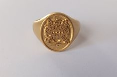 Personalized 925 sterling silver oval signet ring engraved with family crest.It can be engraved with any crest or initials that you want 1.INFORMATION ABOUT RING It is 925 silver. It can be gold filled, if you want solid gold please contact us we gladly do. The rings can have black background ,it depends on your preference please inform us about your preference. 1.1 Ring Face Size Options; Oval Small:9-11 mm Oval Medium:12 -14 mm Oval Large:14-17 mm Oval Xlarge:17-20 mm Round Small:9 mm diameter Heirloom Oval Signet Ring With Coat Of Arms, Gold Oval Signet Ring With Coat Of Arms, Oval Antique Signet Ring As Gift, Antique Oval Signet Ring For Gift, Vintage Engraved Ring With Coat Of Arms For Gift, Elegant Round Jewelry With Coat Of Arms, Classic Jewelry With Coat Of Arms For Gift, Classic Coat Of Arms Jewelry As Gift, Elegant Round Coat Of Arms Jewelry