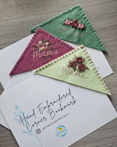 three envelopes with hand embroidered flowers on them, one for mom and the other for grandma