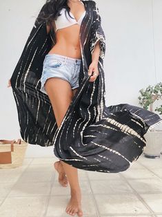 A beautiful unisex kimono, the Maya Tie Dye Kaftan Kimono is handcrafted from 100% soft rayon and features side slits at the hemline and inner loops between wings complemented by breezy sleeves, a basic for remaining cool as temperatures soar. Slip the chic kimono robe over a bikini or part with our Maya boho pants for a look that incorporates luxury style. Features: Handcrafted, Hand tie-dye Maxi length Very comfortable Breathable Removable waist tie closure No sleeves and No pockets as Kaftan Long Beachwear Kimono For Festivals, Oversized Black Bohemian Cover-up, Flowy Open Front Kimono For Festivals, Black Wrap Kimono For Vacation, Casual Black Kimono For Beach Cover-up, Black Summer Kimono With Kimono Sleeves, Black Cover-up With Kimono Sleeves For Beach, Black Long Kimono For Beach Cover-up, Black Beach Cover-up With Kimono Sleeves