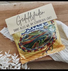 a packet of colorful rubber bands sitting on top of a wooden table