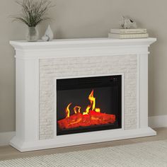 a white fireplace with fire burning in it