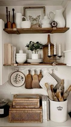 the shelves in this kitchen are filled with dishes and cooking utensils on them