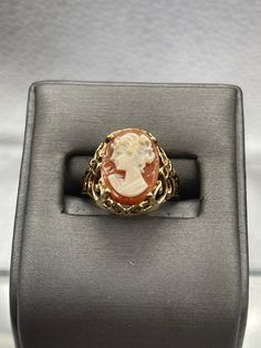 This ring is made in 10 karat yellow gold in a beautiful open scroll design work with a striking cameo on top.  The cameo is carved with amazing detail.   Weight:  4.1 grams Ring Size:  6 ¼  Our Price $425.00 Regularly Priced At $675.00 Please See Our Video Remember - If you're purchasing for yourself or a gift for a loved one, buy with confidence.  We Guarantee Everything We Sell!  SKU # R927 Formal Carved Signet Ring In 14k Gold, Carved 14k Gold Signet Ring For Formal Occasions, Carved Signet Ring In 14k Gold For Formal Occasions, Elegant Carved Signet Ring For Formal Occasions, Formal Oval Engraved Ring With Intaglio, Oval Engraved Ring With Intaglio For Formal Events, Classic Carved Yellow Gold Jewelry, Formal Carved Yellow Gold Rings, Formal Yellow Gold Carved Rings