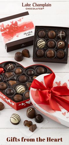 a heart shaped box filled with chocolates next to a valentine's day card