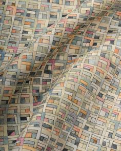 the fabric is very colorful and has many squares on it, as well as an interesting pattern