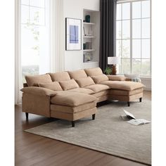 a living room with a sectional couch and large rug in front of the window,