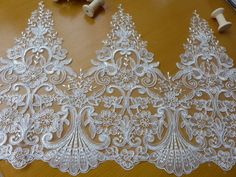 three white lace trims on a table