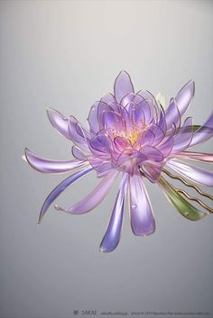 a purple flower is floating in the air