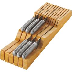 a set of four knives sitting on top of a wooden block with metal blades sticking out of it