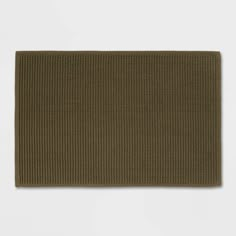 an olive green rug on a white background