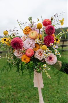 a bouquet of flowers is sitting in the grass