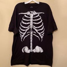 New Condition, Never Been Worn Glow In The Dark Skeleton Torso T-Shirt. 100% Pre-Shrunk Cotton Measurements: Top Shoulder Seam To Top Shoulder Seam 21” Armpit To Armpit 24” Top Of Shoulder To Bottom Front 30” Casual Cotton Top With Glow In The Dark Details, Casual Cotton Glow In The Dark Tops, Casual Black Glow In The Dark Top, Casual Glow In The Dark Crew Neck T-shirt, Casual Glow In The Dark Short Sleeve T-shirt, Black Glow In The Dark Crew Neck Top, Cotton Glow In The Dark T-shirt With Crew Neck, Black Graphic Tee With Glow In The Dark Details, Black Short Sleeve Glow In The Dark T-shirt