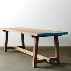 a wooden table sitting on top of a cement floor