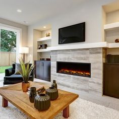 a living room with a couch, coffee table and fireplace