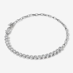 Glam Slam in this tennis chain bracelet! Andre combines the elegance of a tennis bracelet with the edginess of a chain. On one side, high shine crystals are set in a sleek polished row. On the other, a bold, interlocking chain adds a touch of modern sophistication. This versatile piece is the perfect blend of classic and contemporary. Pair this bracelet with a cute drop waist dress for effortless day to night chic. Luxury Silver Tennis Bracelet With Polished Finish, Modern Luxury Sterling Silver Tennis Bracelet, Luxury Modern Sterling Silver Tennis Bracelet, Luxury Silver Channel Set Tennis Bracelet, Luxury Silver Tarnish-resistant Tennis Bracelet, Luxury Silver Art Deco Tennis Bracelet, Pearl Earring Set, Pearl Statement Earrings, Glam Slam