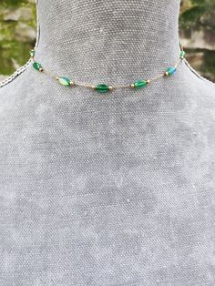 Super dainty emerald green crystal beaded choker made of gold plated stainless steel and beautiful little long ab green crystals. PLEASE read my shop announcement before placing an order so you know what to expect right now. Plus, when ordering from outside Europe, don't forget to provide a phone number for the courier to ensure the fastest and smoothest delivery Stainless steel chain and findings, won't rust or anything  Fastens with a solid lobster clasp, and has an extension chain.   Choker is 13 inches long and comes with an extension chain, but I can make it in your desired length, just ask me. ✨ Another super dainty double chain choker here: https://www.etsy.com/listing/1684657649/dainty-satellite-chain-choker-necklace All my jewelry is nickel and lead free.  I'm so sorry for having Green Emerald Jewelry With Adjustable Chain, Emerald Jewelry With Adjustable Green Chain, Green Metal Choker Jewelry, Green Bohemian Jewelry With Clavicle Chain, Bohemian Green Jewelry With Clavicle Chain, Green Metal Choker Necklace, Bohemian Green Clavicle Chain Jewelry, Green Metal Choker For Party, Bohemian Gold Emerald Necklace With Round Beads