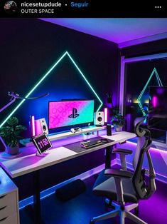 a desk with a computer on top of it in front of a window and neon lights