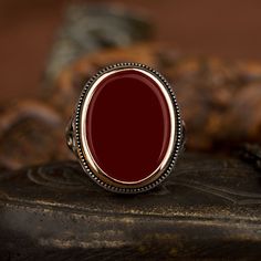 Red Agate Flat Silver Ring For Men. Handmade in 925 sterling silver with agate stone. On the ring Oval flat red aqeeq - agate, onyx stone settled. Covered with yellow color rhodium plated frame. No gold or gold plating settled. Dimensions of stone is 20 mm x 15 mm. Average weight of Red Agate Flat Silver Ring is 14 gr. (depends your ring size). Back side is closed. Classic and exclusive style. Stone Type: Aqeeq - Agate Stone Color: Red Stone Dimensions: 20 mm x 15 mm Stone Shape: Oval, Flat Aver Mens Ruby Ring, Silver Ring For Men, Gothic Men, Silver Men Ring, Average Weight, Men Ring, Popular Jewelry, Ring For Men, Red Agate