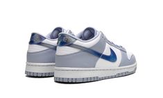 The Nike Dunk Low GS “Blue Iridescent” is the youth sizing of the classic sneaker with a unique-looking Swoosh.  The “Blue Iridescent” Dunk Low features a white leather construction with light blue leather overlays.  On the sides, a Blue Iridescent Swoosh logo adds intrigue to the shoe’s design.  More iridescent accents land on the heel and on the tongue.  The shoe rides on a white rubber midsole and light blue rubber outsole.  Release date: April 1, 2023 Nike Dunk Low Next Nature, Iridescent Shoes, Sneaker Displays, Blue Whisper, Sneakers Box, Kobe Shoes, Royal Green, Basic Hoodie, Sneaker Release