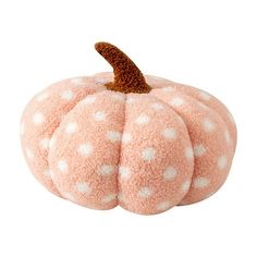 a pink pumpkin with white polka dots on it