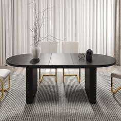 a black table with white chairs and a vase on it in front of a curtained window