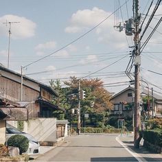 an empty street lined with houses and power lines