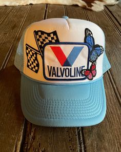 Experience unique style and comfort with our Race Cars & Butterflies Hat! Made by Wild Plains, this Sky Blue/White Foam Trucker Hat features a mesh back and a snap closure for a perfect fit. Adorned with Valvoline, butterfly, and race flag patches, this one-of-a-kind hat will make you stand out from the crowd. Features: Sky Blue/White foam trucker hat Mesh back Snap closure Patches Include: Valvoline Butterflies Race Flags One of a kind Made by Wild Plains ALL SALES ARE FINAL ON ONE OF A KIND TR Blue Snapback Hat With Short Brim For Summer, Blue Summer Snapback Hat With Short Brim, Spring Mesh Cap, Retro Trucker Hat With Curved Brim For Spring, Retro Spring Snapback Hat With Short Brim, Retro Snapback Hat With Short Brim For Spring, Retro Curved Brim Trucker Hat For Spring, Spring Retro Snapback Hat With Short Brim, White Mesh Snapback Hat For Spring