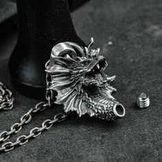 Material: 925 silver, brass Size: 33mm*34mm (thick) Weight: Brass: about 24g                    Silver: about 28g ◆This is a handmade Zombie Urn Pendant. The linked pictures showcase the silver urn pendants, each item is custom made and has a special meaning to you. How special your loved ones and beloved pets are to you, and how sad it is when they leave us. This necklace includes a hollow urn pendant to hold the cremated ashes of your loved one for long-lasting remembrance and companionship. ◆ Gothic Carved Jewelry Gift, Silver Carved Brass Jewelry, Carved Silver Brass Jewelry, Unique Collectible Stainless Steel Jewelry, Collectible Antique Silver Stainless Steel Jewelry, Unique Engraved Stainless Steel Necklaces, Symbolic Jewelry With Steel Shank As Gift, Silver Gothic Jewelry For Ceremonial Occasions, Ceremonial Gothic Silver Jewelry