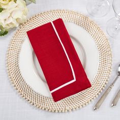 a place setting with red napkins and silverware