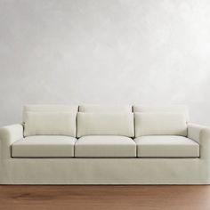 a white couch sitting on top of a wooden floor