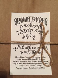 a brown paper package tied up with string and some type of writing on the side