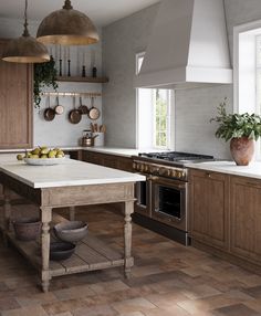 a kitchen with wooden cabinets and an island in front of the stove top, surrounded by hanging pots and pans