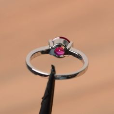 It is a lab ruby ring. The main stone is 7 mm*7 mm round cut.weight about 1.66 carats. The basic metal is sterling silver and plated with rhodium. To change the metal to a solid gold (white/rose) or platinum is also available, please ask for a quotation if you want. You can also go to my shop Home for more elegant rings: https://www.etsy.com/shop/godjewelry?ref=hdr_shop_menu Ruby is the July birthstone. More ruby rings: https://www.etsy.com/shop/godjewelry?section_id=20709238 Customization is al Ruby Birthstone Promise Ring, Round Cut, Ruby Birthstone Promise Ring Round Cut, Ruby Birthstone Promise Ring, Ruby Birthstone Ring For Promise, Ruby Birthstone Ring For Anniversary, Round Cut Ruby Promise Ring With Center Stone, Ruby Birthstone Ring In Round Cut, Formal Jewelry With Lab-created Ruby In Round Band, Formal Jewelry With Lab-created Ruby In Round Shape