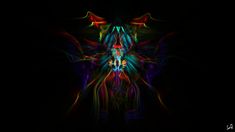 an abstract image with many colors and shapes in the dark, it looks like something out of