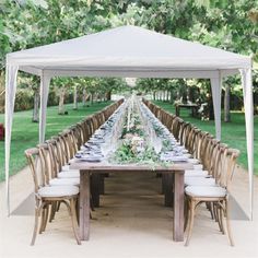 a long table is set up under a white tent