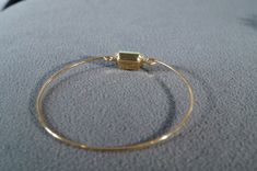 I am offering this fabulous vintage bracelet. This piece is truly gorgeous, and it has the following features: * beautiful vintage bracelet * yellow gold tone * square * glass stone * bangle * 2.5 inches in width This is a fantastic and classic piece. There is tons of sparkle and shine with this piece. It will beautifully complement your upcoming fashion season. Buyer pays all shipping and handling Adjustable Square Gold Bracelet, Gold Jewelry With Rectangular Stone For Wedding, Vintage Jewelry With Gold Rectangular Stone, Elegant Square Brass Jewelry, Gold Square Bracelets For Gift, Gold Square Bracelets As Gift, Vintage Brass Rectangular Jewelry, Vintage Rectangular Brass Jewelry, Vintage Yellow Gold Jewelry With Rectangular Stone