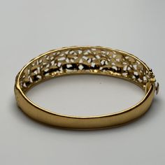 This is part of Chairish’s Fine Jewelry assortment.  This bangle is hand-crafted out of 18 karat yellow gold. It features delicate, florentine engravings of leaves and small flowers. The clasp contains one safety clasp.   Weight: 17.75g Size: 6.5" Luxury Yellow Gold Bangle For Evening, Intricate Design Gold Bracelet For Formal Occasions, Exquisite Yellow Gold Bangle For Anniversary, Yellow Gold Filigree Bracelet For Formal Occasions, Luxury Yellow Gold Engraved Bangle, Formal Yellow Gold Bracelet With Filigree, Exquisite Gold Bangle For Formal Occasions, Gold Hinged Bracelet For Weddings, Formal Yellow Gold Bracelet With Intricate Design