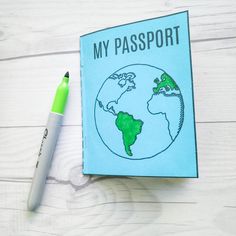 a passport sitting on top of a table next to a pen