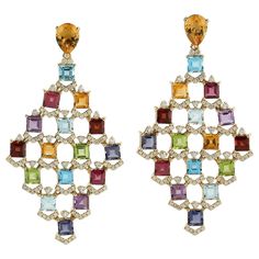 These multi gemstone earrings are handmade in 18 Karat gold. It is beautifully detailed with 19.95 carats amethyst, citrine, garnet, peridot, topaz and 1.39 carats of sparkling diamonds. FOLLOW MEGHNA JEWELS storefront to view the latest collection & exclusive pieces. Meghna Jewels is proudly rated as a Top Seller on 1stDibs with 5 star customer reviews. All items manufactured by us are handmade and can be customized or redesigned. Composition Size-57X30 MM Total Weight-22.81 Gold Weight(Gms)-19 Diamond Dangle Earrings, Art Deco Diamond, Blake Lively, Sparkle Diamonds, Diamond Gemstone, Chandelier Earrings, Gemstone Earrings, Earrings Handmade, Citrine