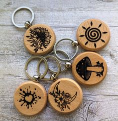 four wooden keychains with pictures of sunflowers and other things on them