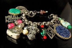 "This is a very beautiful and vintage NAPIER NAPIER ASIAN BUDDHA ART GLASS SILVER TONE bracelet. The bracelet has a marvelous shape with 14 charms in Asian style, Buddha, Chinese symbols, , coins,, art glass and silver tone metal in nice quality. Th bracelet has a very extravagant and elegant feel to it. It measures 7 1/4\" x 2\". The bracelet is in very good condition. 07 BR" Antique Good Luck Charms Jewelry, Spiritual Decorative Silver Jewelry, Spiritual Silver Decorative Jewelry, Vintage Engraved Jewelry For Good Luck, Antique Silver Spiritual Charms Jewelry, Antique Silver Spiritual Jewelry With Charms, Spiritual Antique Silver Charms Jewelry, Spiritual Antique Silver Jewelry With Charms, Handmade Spiritual Silver Charm Bracelet