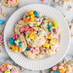 a white plate topped with cookies covered in m & m candies and chocolate chips